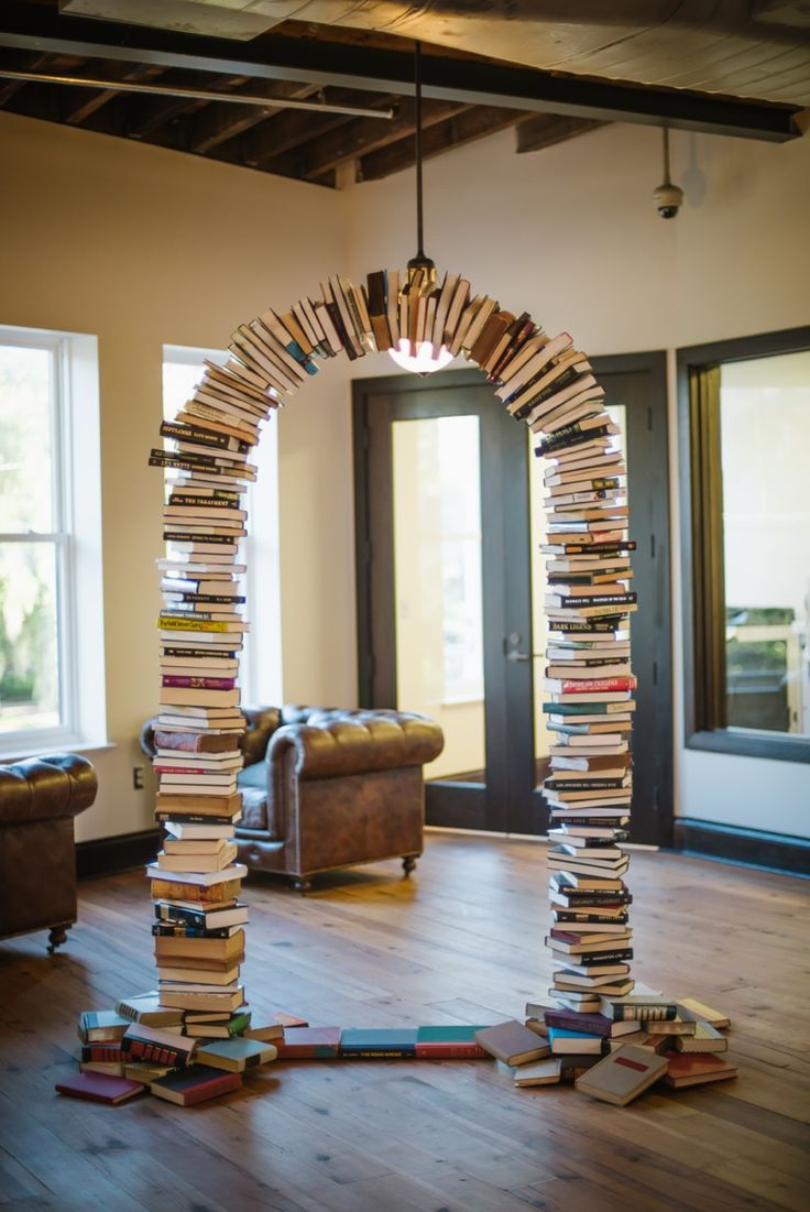 an arch made out of books in the middle of a living room