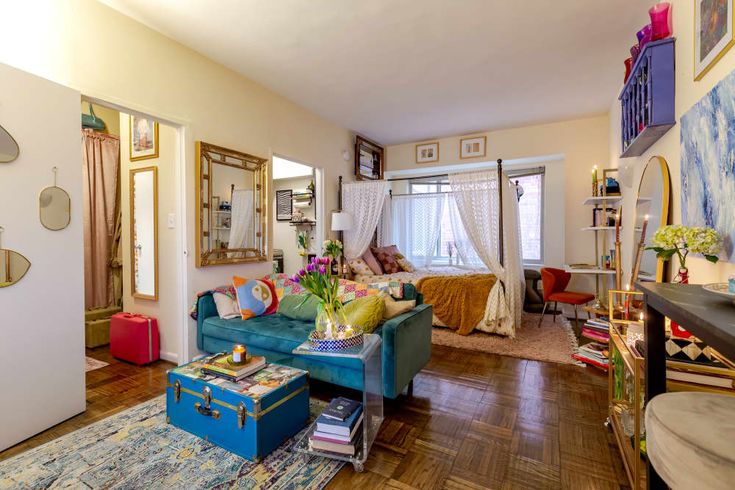 a living room filled with lots of furniture and decor on top of a hard wood floor