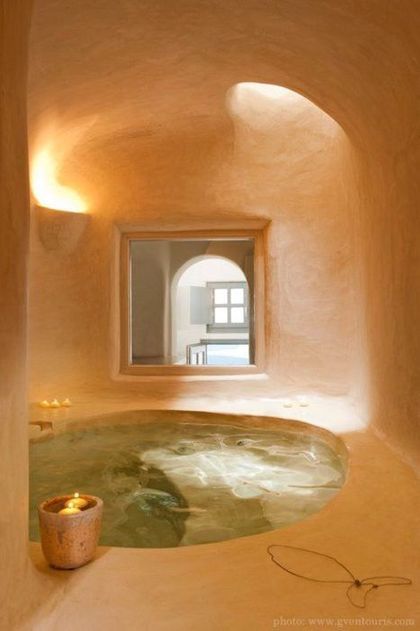 an indoor jacuzzi is shown in the middle of a room with a round window