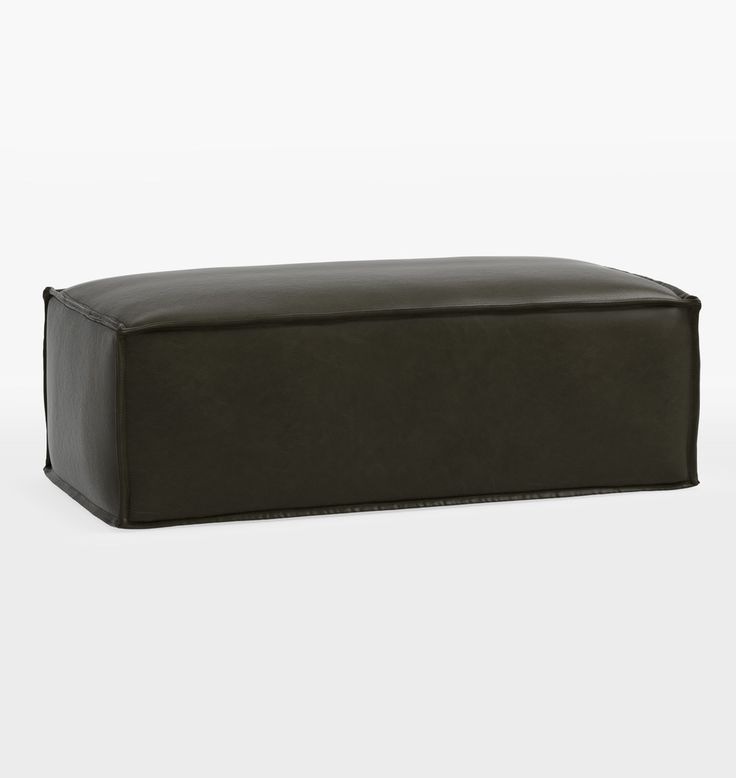 a black leather ottoman sitting on top of a white floor