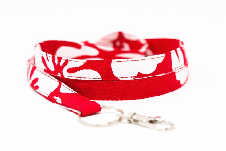 "New Feature  A half twist is added to the strap  to allow the lanyard to lay flat around  your neck and on your chest. ❤︎ Dimensions     Strap: 0.5\" wide x 18.5\" or 16.5\"length     Swivel clasp: 1.5\" - 2.25\" length       Need a different length? Send me a message. ❤︎ Fabric     100% cotton Hawaiian fabric      ❤︎ Add on      Horizontal ID card case       It holds standard credit card sized ID.      Dimensions: 3 7/8\" wide x 3 1/4\" hight Add an ID case to your lanyard here. www.etsy.com/listing/1060717453" White Lanyards With Key Clip For Everyday Use, White Lanyard With Key Clip For Everyday Use, White Lanyards With Key Clip, Red Lanyards With Key Leash For Gifts, Red Lanyard With Key Leash As Gift, Red Lanyards With Key Leash, Adjustable Red Lanyard With Key Leash, White Adjustable Lanyard With Key Leash, Adjustable White Lanyard With Key Leash