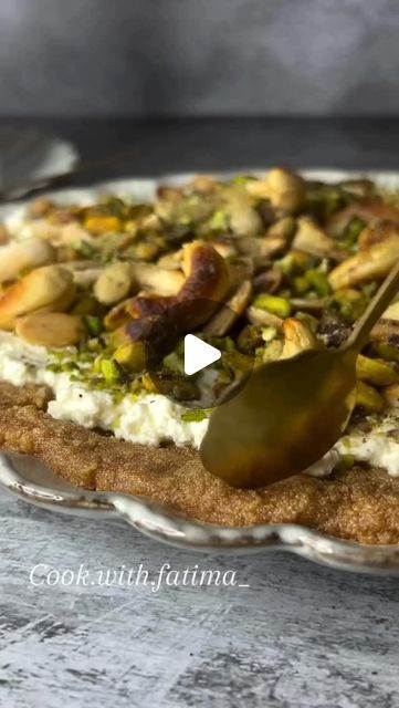 a pizza with pistachios and other toppings is being served on a platter