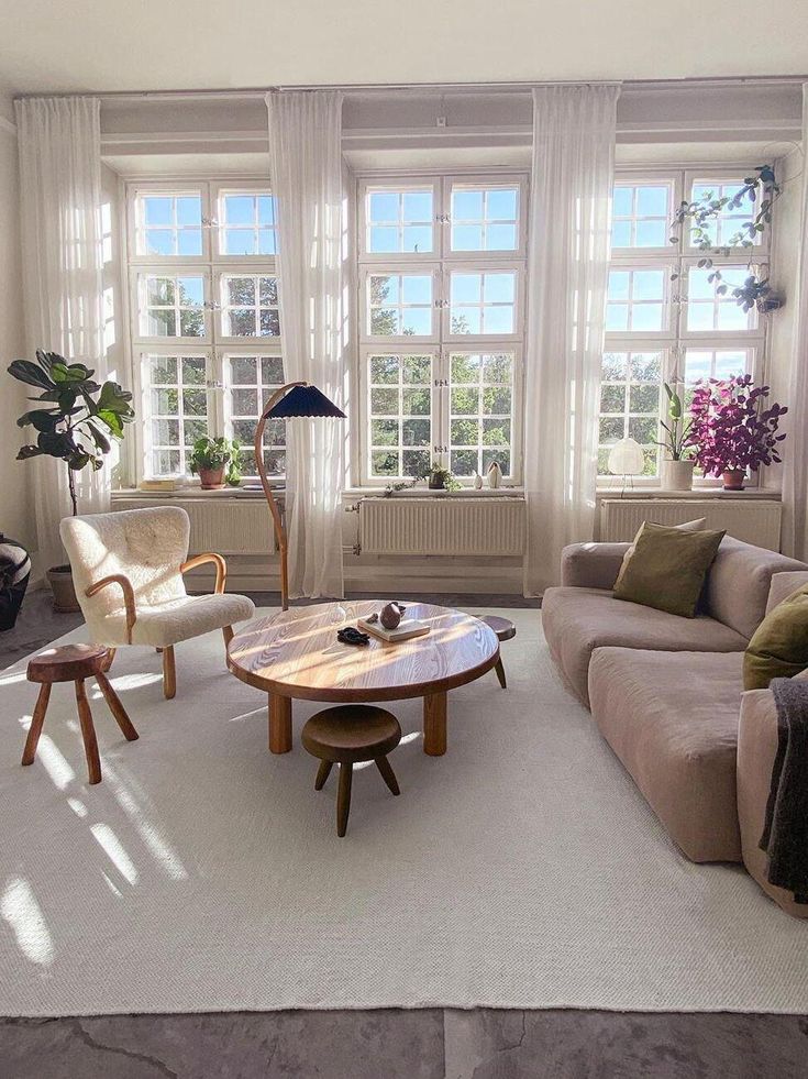 a living room filled with furniture and windows