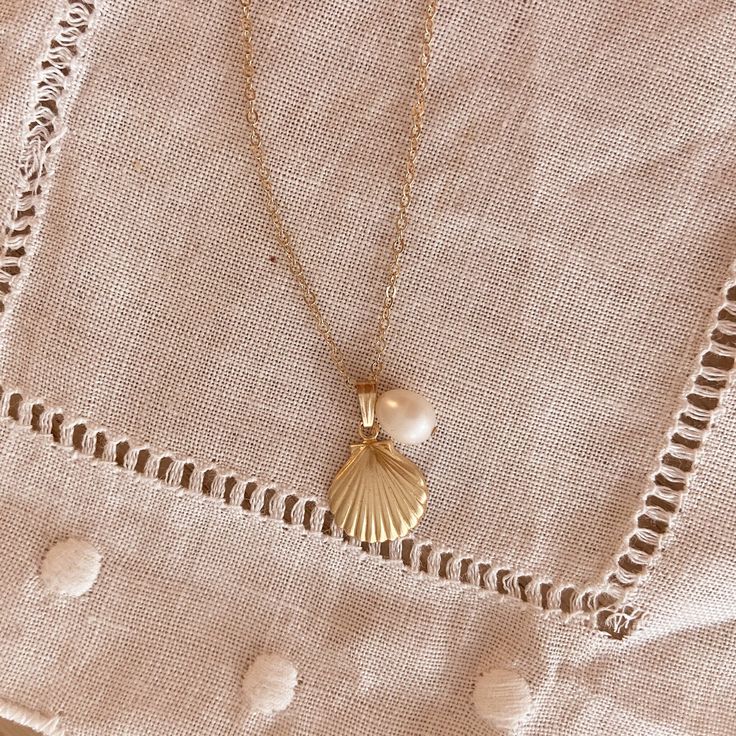 Gold seashell and baroque pearl necklace As you journey through life and collect treasure along the way, may you connect with the strength and the power of the ocean through these little sea treasures. They may be tiny in size, but it's large in its symbolism. Pearl and seashell, previously seen as the rebirth of the goddess Venus in Greek ancient myth, now represent fertility and resurrection. Wherever you're going, keep these treasures close to your heart, may the strength and the power always follow you. Feature:  Gold-filled seashell and baroque pearl charm Size: 38+5cm adjustable White Ocean-inspired Charm Necklace For Gift, Ocean-inspired White Charm Necklace As Gift, Ocean-inspired White Charm Necklace Gift, White Shell Charm Necklace As Gift, White Shell Charm Necklace For Gift, Dainty Shell Necklaces Perfect As Gifts, Shell Pendant Jewelry With Pearl Charm, Ocean-inspired Pearl Pendant Necklaces As Gifts, White Shell Charm Necklace Gift