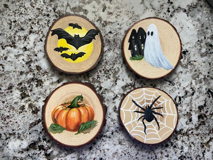 four wooden slices decorated with halloween decorations