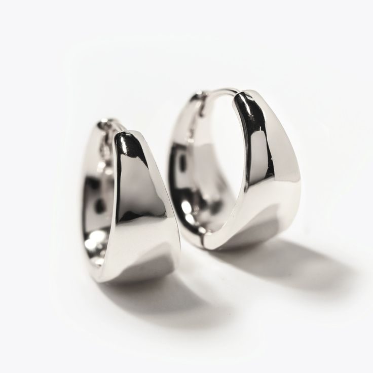 These statement small hoops feature a unique teardrop silhouette, adding a feminine twist to a bold look. Elevate your style and make a statement with these luxurious Sterling Silver hoop earrings. Sterling Silver Inside Diameter 0.5in(13mm), Width 0.3in(8mm) Click closure E190-13S Modern Metal Huggie Earrings For Formal Occasions, Modern Metal Huggie Hoop Earrings, Trendy Silver Hoop Earrings For Formal Events, Trendy Silver Hoop Earrings For Formal Occasions, Modern Metal Hoop Huggie Earrings, Modern Teardrop Huggie Earrings With Polished Finish, Modern Metal Hoop Earrings, Modern Nickel-free Hoop Earrings For Formal Occasions, Modern Nickel-free Hoop Earrings For Formal Events