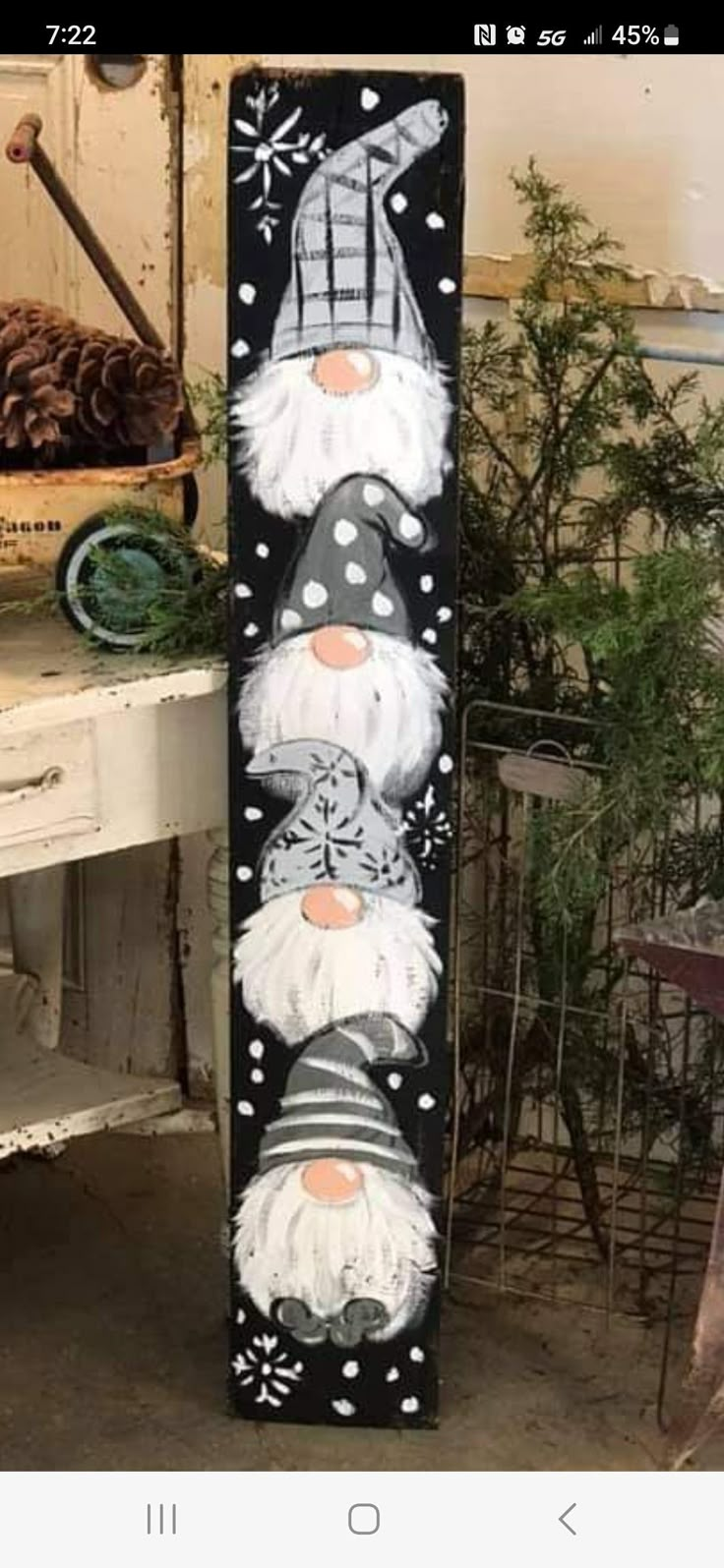 this is an image of a painted wooden sign with santa clauss on it and snowflakes