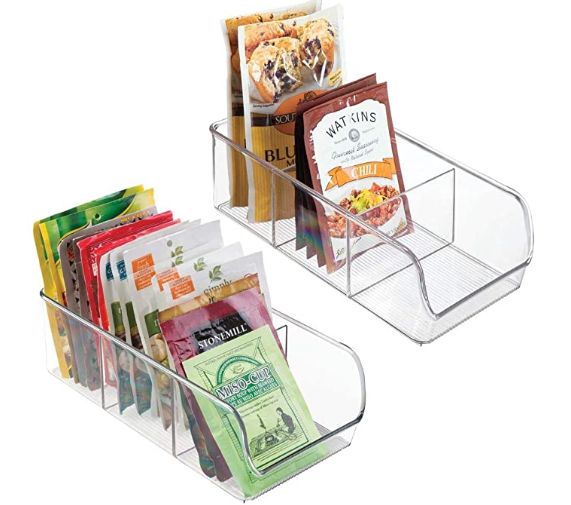 two clear bins with food and snacks in them on a white background for display