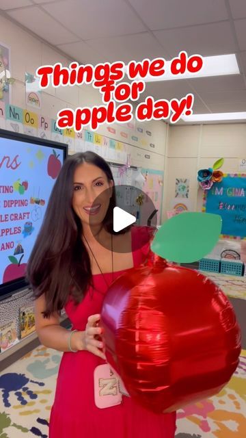 a woman in a red dress holding an apple shaped balloon with the words things we do for apple day