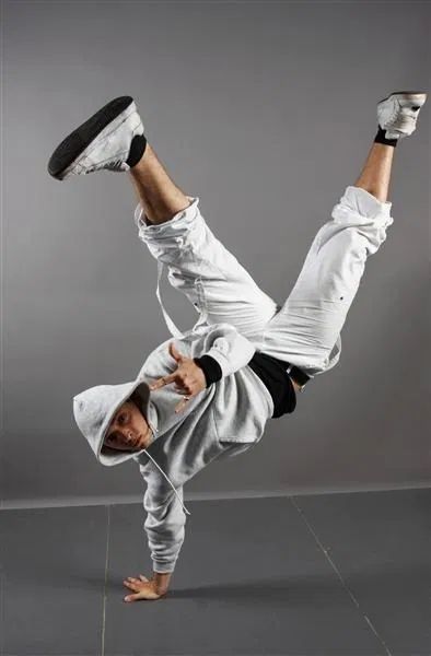 a man doing a handstand on one leg with his feet in the air