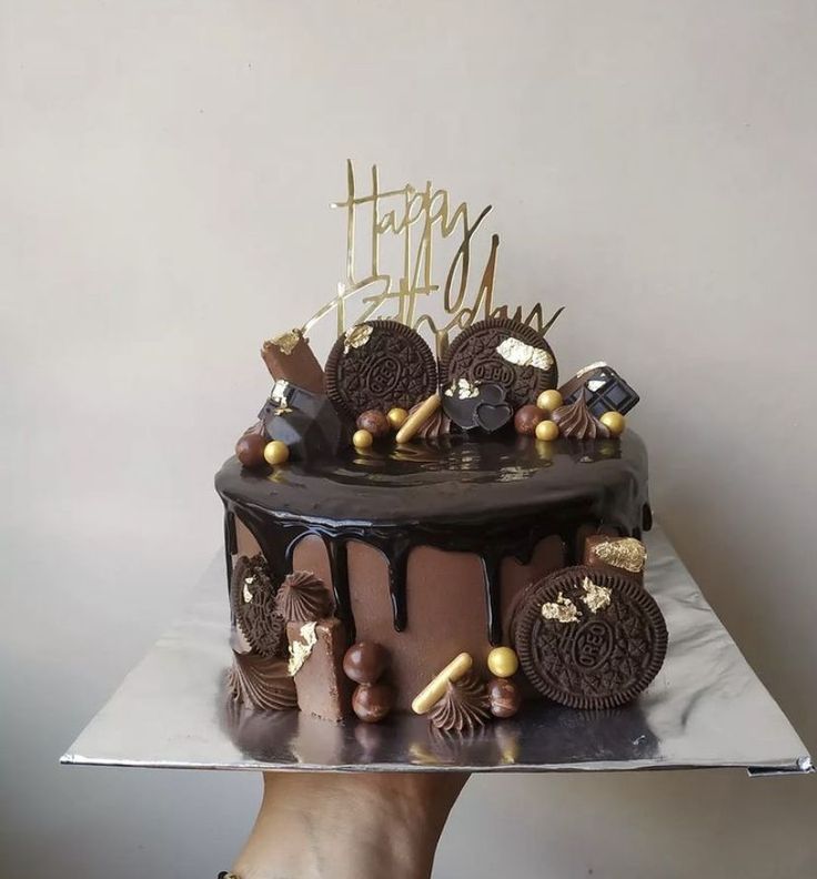 a birthday cake with oreo cookies and chocolate frosting