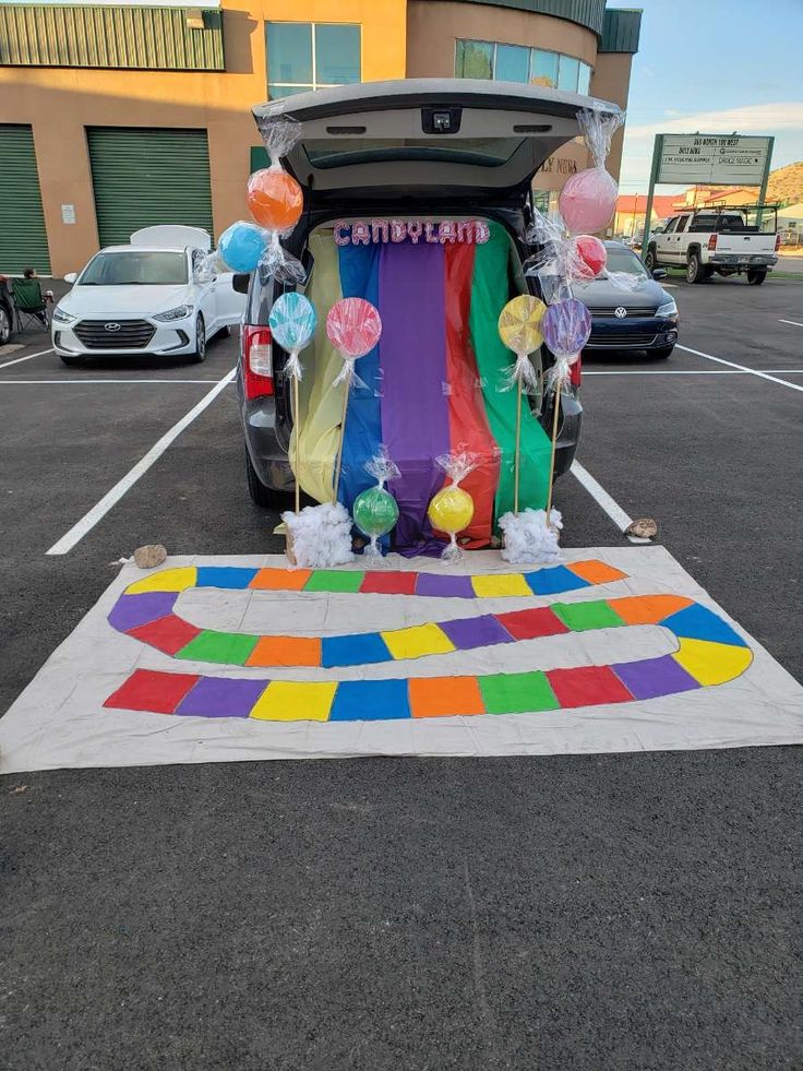 the trunk of a car decorated with balloons and streamers