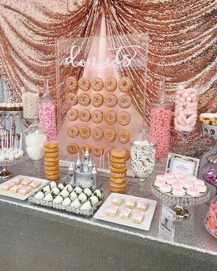 a dessert table with donuts and cookies on it