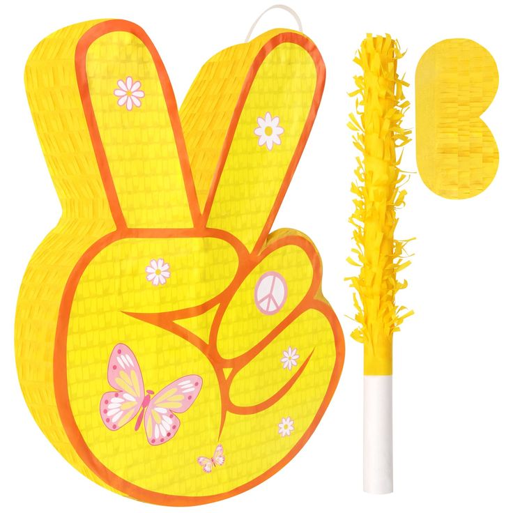 a yellow peace sign with flowers and butterflies on it, next to a plastic brush