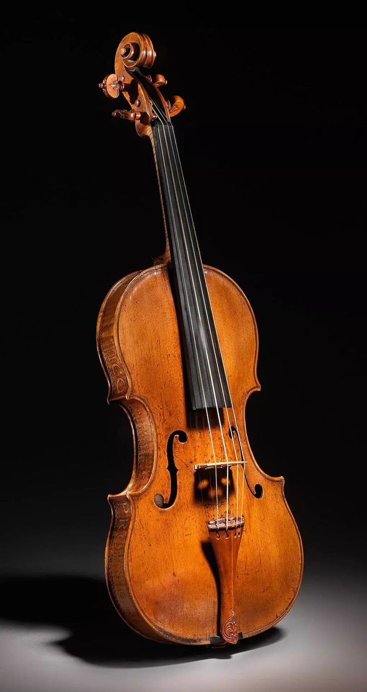 an old violin sitting on top of a table