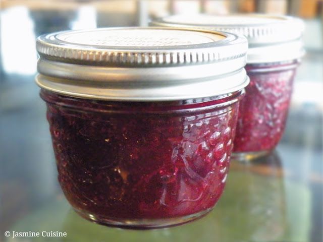 two jars filled with jam sitting on top of a table