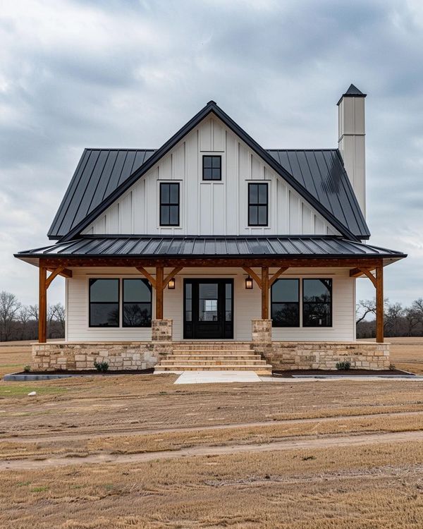 a large white house sitting on top of a dry grass field