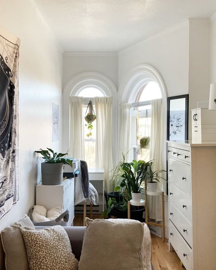 a living room filled with furniture and lots of windows next to a wall mounted clock