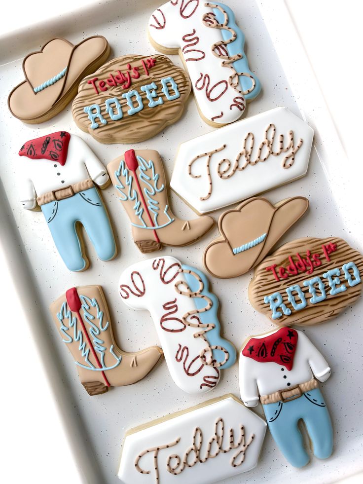 decorated cookies in the shape of men and women are on a white tray with words that read today, today, today, today