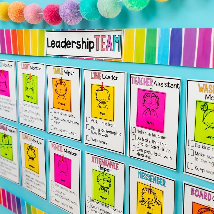 a bulletin board with colorful papers and pom - poms