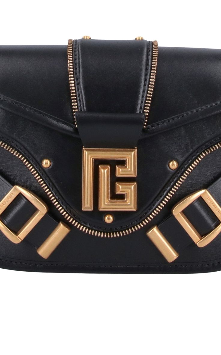 The Balmain Blaze Leather Shoulder Bag in black boasts an adjustable top leather shoulder strap for added convenience, secured with a snap flap closure. Its gold flap logo and double buckle detail on the front add a touch of sophistication. Plus, the bag features a flat back pocket and interior flat pocket within the spacious main compartment. Size and fit: H 6"/15cm X L 9"/23cm X D 2.75"/7 cmStrap span: 24.9"/63 cmComposition: 100% Calfskin LeatherHardware: Golden metalSignature dust bag includ Chevron Jewelry, Shoes Flats Sandals, D 2, Belt Bag, Leather Crossbody Bag, Bag Sale, Leather Crossbody, Leather Shoulder Bag, Calf Leather