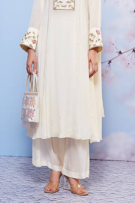 Buy Ivory Chiffon Embroidered Floral Round Kurta Palazzo Set For Women by Ajiesh Oberoi Online at Aza Fashions. Cream Sharara With Resham Embroidery In Georgette, Elegant Off White Georgette Sharara, Elegant Off-white Georgette Sharara, Off White Anarkali Palazzo Set With Intricate Embroidery, Elegant Georgette Sharara With Floral Embroidery, Cream Straight Kurta Set For Wedding, Off White Palazzo Set With Intricate Embroidery For Eid, Elegant Cream Georgette Palazzo Set, Festive Cream Georgette Palazzo Set