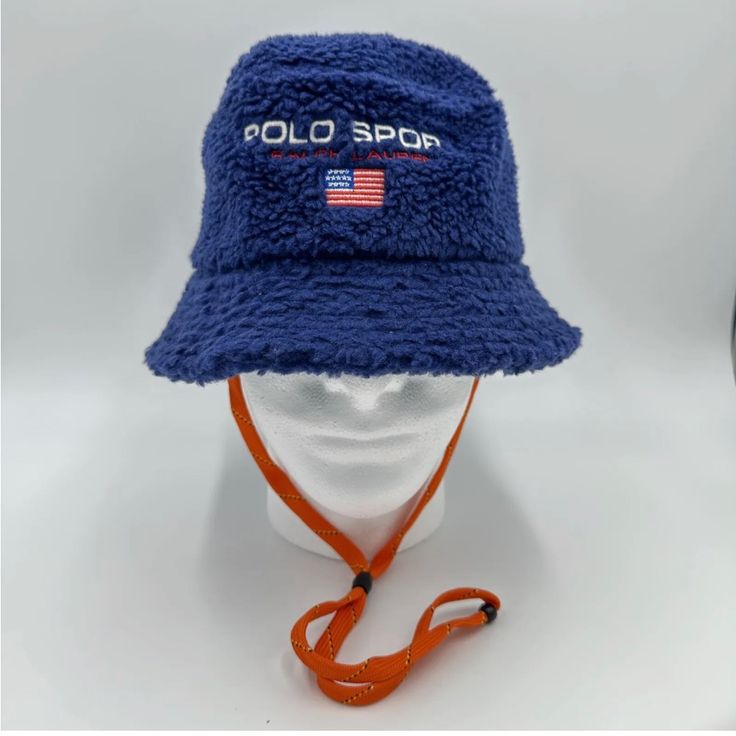 Polo Ralph Lauren Men’s Polo Sport Logo Fleece Bucket Hat Blue Size S/M Come With String But Can Be Taken Off Easily.Unisex Blue Bucket Hat For Outdoor, Sporty Winter Hats With Adjustable Fit, Sporty Adjustable Winter Hats, Navy Casual Winter Hats, Blue Sports Bucket Hat, Blue Bucket Hat For Sports, Navy Adjustable Hat For Winter, Casual Hats With Fleece Lining And Curved Brim, Navy Adjustable Winter Hat