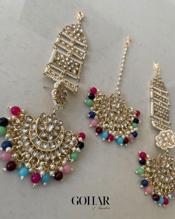 A gorgeous earrings and tikka set with ear chains (sahara) to instantly elevate your look. Bohemian Gold Sets For Eid, Elegant Multicolor Tikka For Festive Occasions, Festive Fusion Style Gold Tikka, Elegant Multicolor Chandbali Tikka, Multicolor Chandbalis With Tilla For Eid, Fusion Style Tikka With Latkans For Festivals, Multicolor Tilla Chandbalis For Eid, Elegant Multicolor Tikka For Diwali, Elegant Multicolor Festive Tikka