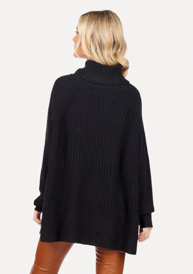 Featuring an oversized turtleneck, ribbed hem, side split hems, and ribbed details throughout, this Freddie sweater in black will keep you warm and fashionable. The length makes it ideal for pairing with your favorite leggings. Winter Turtleneck With Ribbed Funnel Neck, Winter Funnel Neck Turtleneck With Ribbed Neckline, Oversized Fall Turtleneck With Ribbed Collar, Oversized Turtleneck With Ribbed Collar For Fall, Oversized Ribbed Collar Turtleneck For Fall, Oversized Cable Knit Turtleneck, Oversized Cable Knit High Neck Turtleneck, Ribbed Turtleneck Outerwear, Oversized Ribbed Turtleneck Sweater