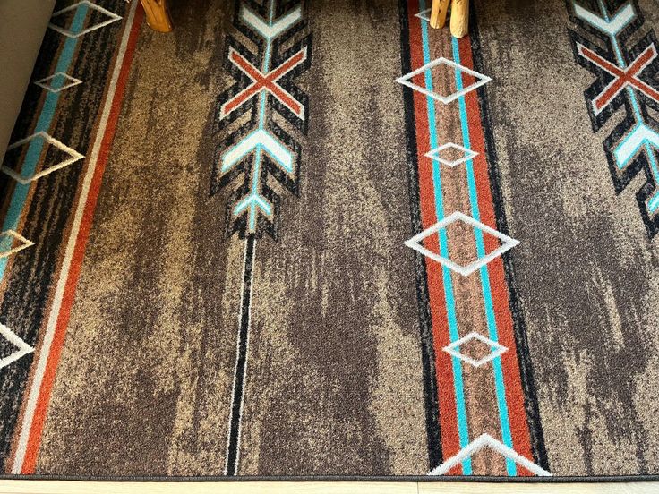 an area rug with arrows and stripes on it