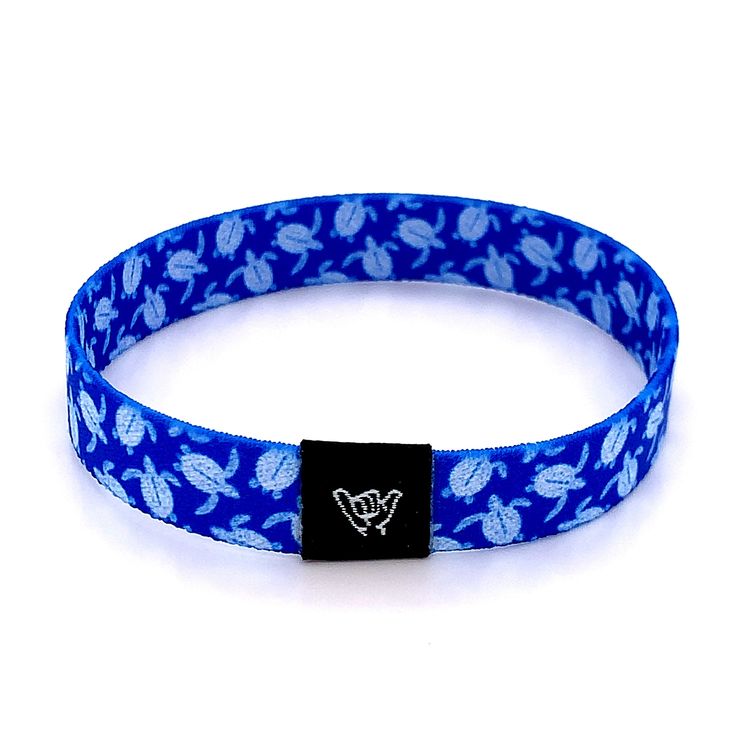 "Show your love for the ocean's cutest sea creature with this vibrant blue sea turtle bracelet. Get ready to make waves with these beachy bracelets! Super comfy on your wrist and they keep their vibrant colors all summer long. Stack them up, mix and match with our knotband bracelets. Available in bracelet lengths (L): Extra Small approx 5.5\" L Small approx 6.5\" L Medium approx 7.5\" L Reversible surf, music and beachy prints. Elastic blend material, can stretch to desired fit. Packaged in natu Adjustable Blue Ocean-inspired Friendship Bracelets, Flexible Blue Summer Bracelet, Adjustable Blue Ocean-inspired Bracelet, Flexible Blue Beach Jewelry, Flexible Blue Jewelry For Beach, Blue Flexible Jewelry For The Beach, Blue Flexible Casual Bracelet, Adjustable Turtle Bracelet For Beach, Casual Blue Flexible Bracelets