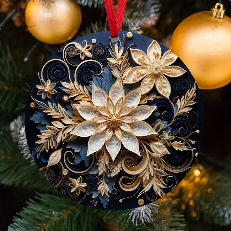 an ornament hanging from a christmas tree decorated with gold and white flowers on it