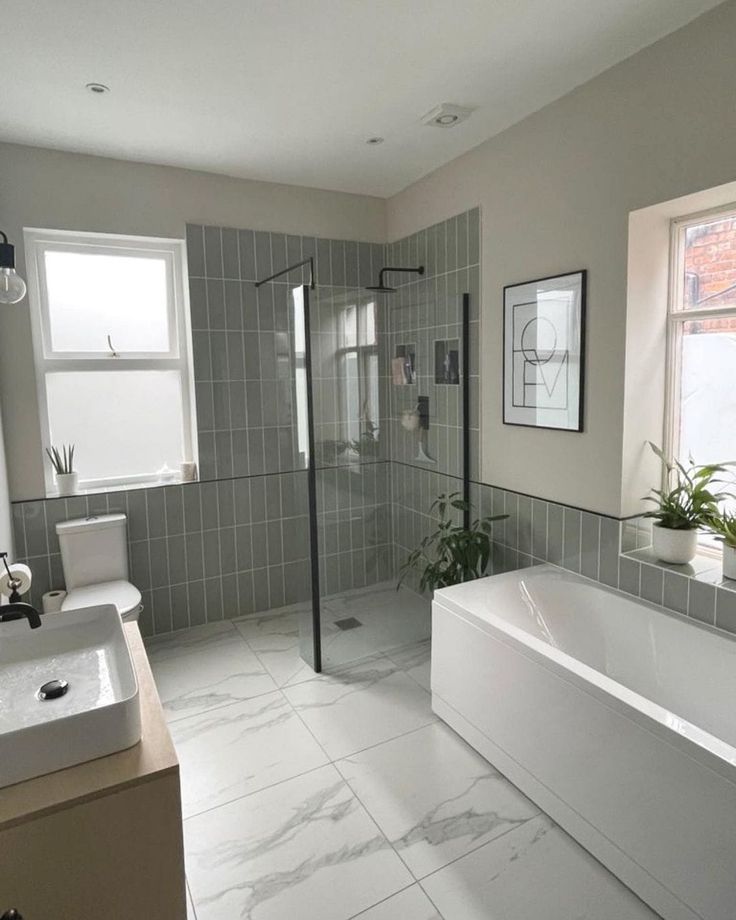 a bathroom with a tub, sink and toilet