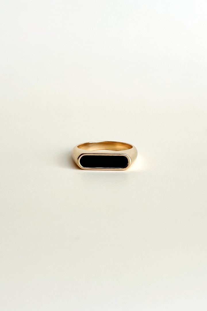 Elevate any outfit with the Emelia Black Ring. Made with 18K gold plating and a black enamel rectangle, this statement ring adds a touch of edginess to your look. Stand out and make a bold statement with this piece! All of our jewelry comes with a free jewelry pouch and cloth to keep your pretties safe and clean. Details Color: 18K Gold PlatedMaterial: Stainless SteelSize: 6, 7, 8 Care Guide Store in a dry, cool place away from sunlight i.e. Blush & Bliss pouch Gently wipe with a soft cloth afte Elegant Black Signet Ring For Everyday, Elegant Black Everyday Signet Ring, Black Minimalist Signet Ring For Everyday, Black 14k Gold Open Signet Ring, Elegant Black Rectangular Signet Ring, Black Rectangular Signet Ring For Formal Occasions, Elegant Onyx Rectangular Signet Ring, Elegant Gold Signet Ring With Black Enamel, Black Minimalist Signet Ring For Formal Occasions