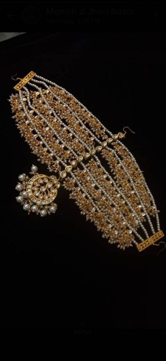 an elaborate gold and crystal necklace with matching earrings