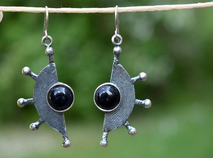 "Unique unusual earrings with gemstone. Made from bronze or sterling silver and decorated with black onyx. Handmade and designed by a jeweler with more than 30 years of experience in jewelry making and designing. Bronze earrings have sterling silver 925 hooks. Please note, that each gemstone is unique, therefore the color of the stone can slightly differ from the ones you see in the pictures. If you would like to order the same design earrings in sterling silver 925 or with another gemstone, ple Black Gemstone Earrings For Anniversary, Unique Black Pierced Earrings, Silver Onyx Earrings Perfect As A Gift, Modern Black Earrings For Anniversary, Modern Black Jewelry With Oxidized Finish, Modern Black Sterling Silver Earrings, Pierced Onyx Round Jewelry, Traditional Black Sterling Silver Earrings, Modern Black Oxidized Jewelry