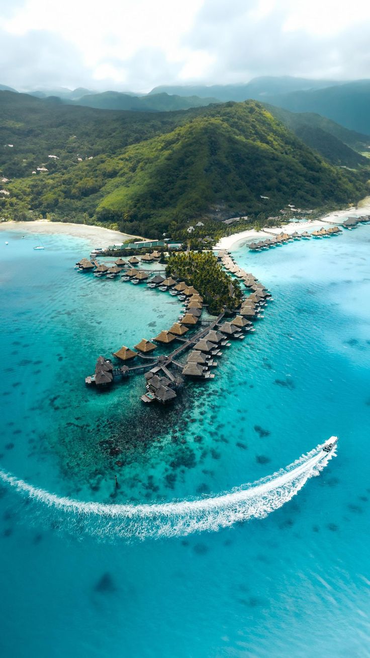 an aerial view of a resort on the ocean