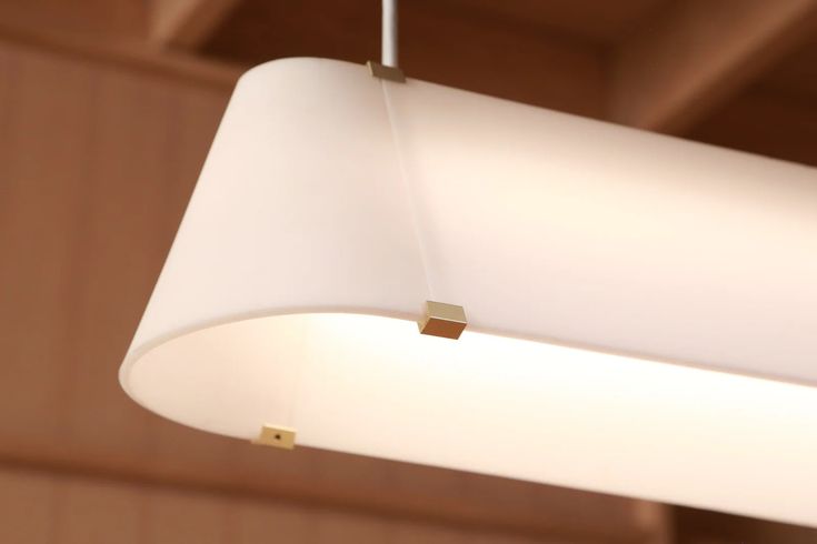 a white lamp hanging from the ceiling in a room