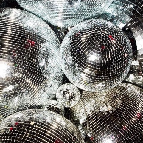 many shiny disco balls piled on top of each other