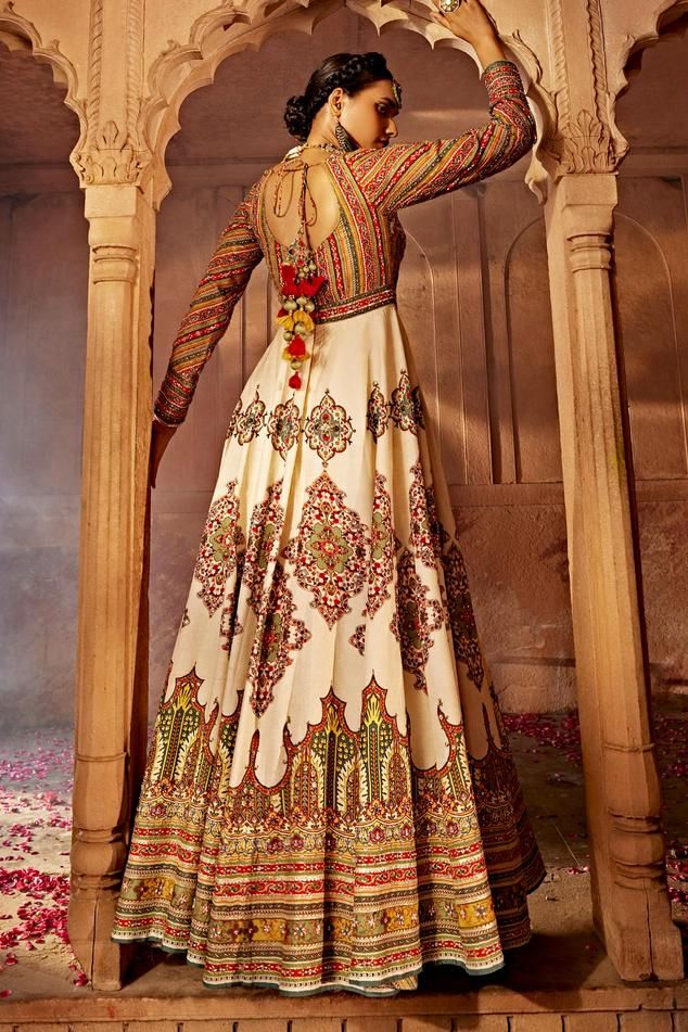 Off white and multi color padded bodice and attached cancan anarkali with floral embroidery on the yoke, persian motif print on the flare, accentuated with sequins and beads. Comes along with a dupatta with contrast embroidered border.
Components: 2
Pattern: Print, Embroidery
Type Of Work: Persian Motif, Flower, Beads, Sequins
Neckline: Tear Drop Neck
Sleeve Type: Full Sleeves
Fabric: Anarkali: Raw Silk, Dupatta: Soft Net
Color: Off White,Multi Color
Other Details: 

Length: 58 inches
Model heig Semi-stitched Embroidered Gown For Navratri, Multicolor Embroidered Gown With Resham For Eid, Multicolor Embroidered Gown With Resham Embroidery For Eid, Multicolor Embroidered Gown For Eid, Festive Semi-stitched Gown With Multicolor Embroidery, Floor-length Salwar Kameez With Intricate Embroidery For Navratri, Floor-length Anarkali Set With Intricate Embroidery For Festivals, Traditional Jamawar Gown With Resham Embroidery, Navratri Floor-length Salwar Kameez With Intricate Embroidery