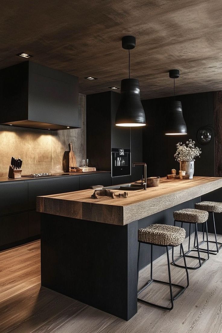 a kitchen with black cabinets and stools next to an island in the middle of the room