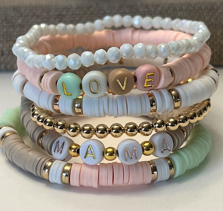 "Custom Word Heishi Stack Bracelets / Pastel Beaded Heishi Bracelets \"MAMA...LOVE...FAMILY\" Fun!  Trendy!  So Pretty! *Listing includes one bracelet  *Option to choose 1 or more bracelets *Let me know your choice of 7 bracelets (A,B,C,D,E,F,Gold) in the Note to Seller box at checkout.  *Customize by choosing Words to replace \"MaMa\", \"Family\", \"Love\"   in the personalization box. If no words chosen you will receive the default words shown. *Placed in a burlap drawstring bag (or a gift box Pastel Beaded Bracelets Gift, Pastel Beaded Bracelets For Gift, Adjustable Pastel Beaded Bracelet, Adjustable Pastel Beaded Bracelets As Gift, Adjustable Pastel Bracelets With Round Beads, Adjustable Pastel Jewelry With Letter Beads, Pastel Letter Beads Bracelet As Gift, Pastel Letter Beads Bracelet For Gift, Adjustable Pastel Beaded Bracelets For Friendship