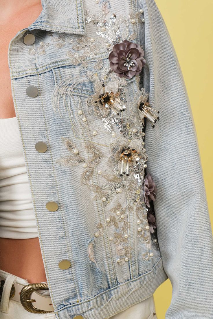 Light blue flower embellished jean jacket. This jacket is the perfect blend of style and fun. The light blue color is perfect for any outfit (whether you're serious about fashion or not). Plus, the delicate flower embellishments add a unique touch that you won't find anywhere else. Bring some floral fun to your wardrobe with this jean jacket! Spring Denim Embellished Outerwear, Spring Embellished Denim Outerwear, Trendy Floral Embroidered Denim Jacket For Spring, Spring Embellished Blue Denim Jacket, Embellished Blue Denim Jacket For Spring, Spring Party Outerwear With Floral Embroidery, Spring Denim Jacket With Floral Embroidery, Spring Party Casual Denim Jacket, Spring Light Wash Denim Jacket