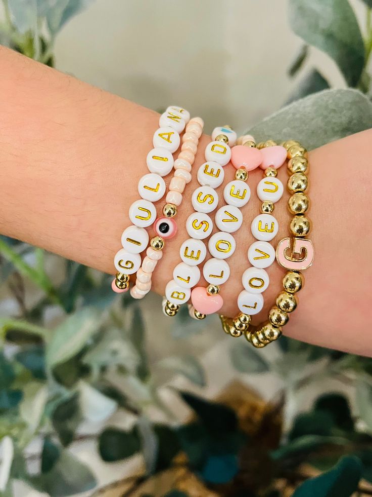 If you're looking to get your mini me or a little diva you know their own stack... look no further 💕 They'll be rockin' these adorable bracelets anywhere they go.  Extremely customizable to suit the style of your little princess.  Choose the color beads. Choose the letter style beads. Initial letter (accent bead) Colored heart /Evil eye. (accent bead) Names/wording  All gold beads are 14K Gold plated.  ALL BRACELETS WILL BE CHILD SIZE EITHER 5.5 INCHES OR 6 INCHES. (PLEASE SPECIFY) 👑 3 STACK Trendy Name Bracelet For Valentine's Day, Personalized Pink Charm Bracelet, Trendy Name Bracelet With Letter Beads For Valentine's Day, Trendy Letter Beads Name Bracelet For Valentine's Day, Trendy Valentine's Day Name Bracelet With Letter Beads, Fun Pink Personalized Name Bracelet, Fun Personalized Pink Name Bracelet, Trendy Pink Bracelets With Custom Name, Trendy Pink Custom Name Bracelets