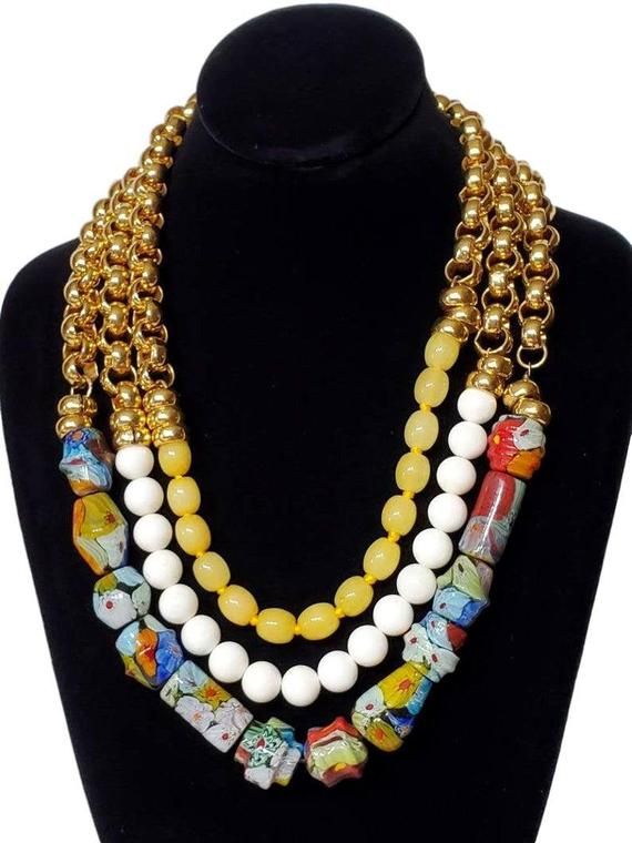 Beautiful vintage Murano glass beads and dyed jade beads create a one of a kind necklace. Gold rings add shine to the top half of each strand. The necklace has a toggle clasp.●Shipping: free domestic shipping - limited time!●Dimensions: L:22"●Linda's Designers Group features a collection of unique fine china, luxury estate sale handbags, vintage statement jewelry and handmade 'one of a kind' jewelry. We will gladly provide additional images or information, contact us through this site or our Fac Oval Glass Gemstone Beads Jewelry, Glass Multi-strand Jewelry With Large Beads, Vintage Czech Glass Colorful Beads Jewelry, Multi-strand Glass Beaded Jewelry, White Czech Glass Beaded Chain Necklace, White Glass Beaded Necklace With Large Beads, Multi-strand Glass Bead Jewelry, Vintage Czech Glass Bead Jewelry, White Bohemian Necklace With Czech Glass