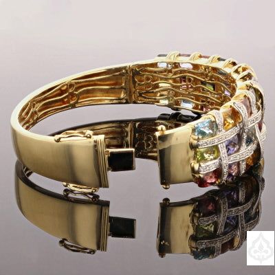 This Multi Stone Gold Cuff is a stunning piece that is sure to make a statement. Made of 18K yellow gold, this cuff features multiple stones that add color and sparkle to its unique design. With a weight of 50.4 grams, this cuff is a substantial and solid piece that can elevate any outfit." Specifications: Metal: 18K Yellow Gold Weight: 50.4g Stone Type: Multiple Stones Unfortunately, an item code is not provided. Please provide the item code to receive accurate information. This cuff is a versa Luxury Multicolor Bangle For Formal Occasions, Luxury Gemstone Cuff Bracelet For Anniversary, Luxury Cuff Bracelet Bangle With Gemstone Accents, Formal Multi-stone Bangle Fine Jewelry, Elegant Multicolor Cuff Bracelet, Fine Jewelry Multi-stone Bangle, Yellow Gold Multi-stone Bangle In Fine Jewelry Style, Luxury Multicolor Bangle, Fine Jewelry Yellow Gold Multi-stone Bangle