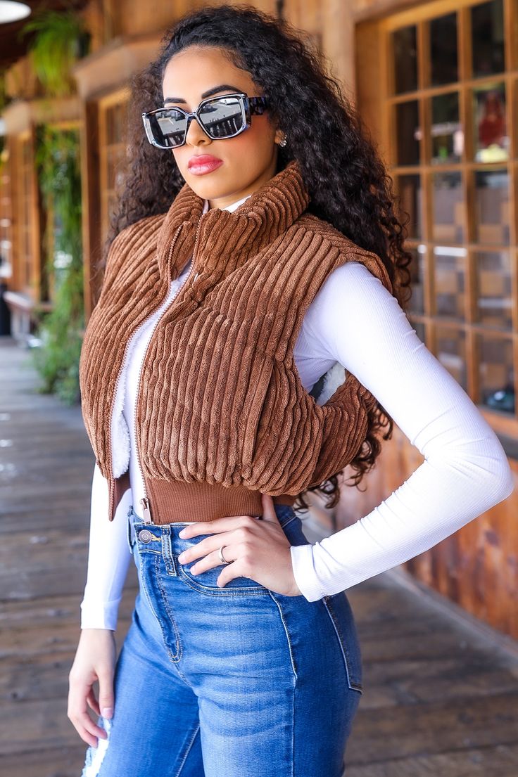 Stay stylish with our High Neck Puffer Vest! This versatile vest features a high neck to keep you cozy and on-trend. Perfect for layering for a casual yet chic look. Say goodbye to boring outerwear and hello to this must-have addition to your wardrobe. Model is wearing a size small