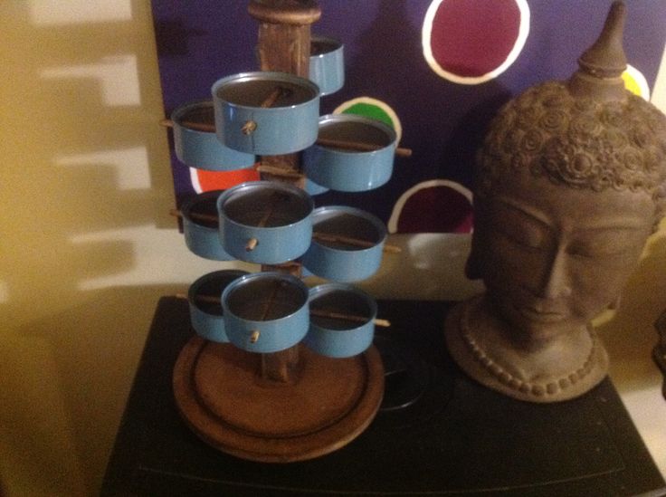 there is a buddha statue and cups on the table