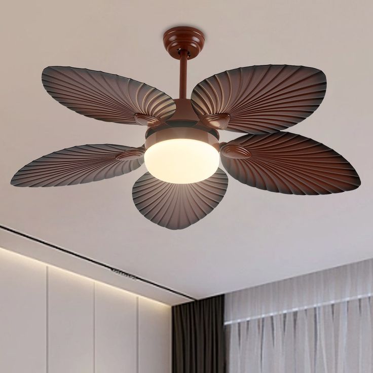 a ceiling fan that is mounted to the ceiling in a room with white walls and curtains