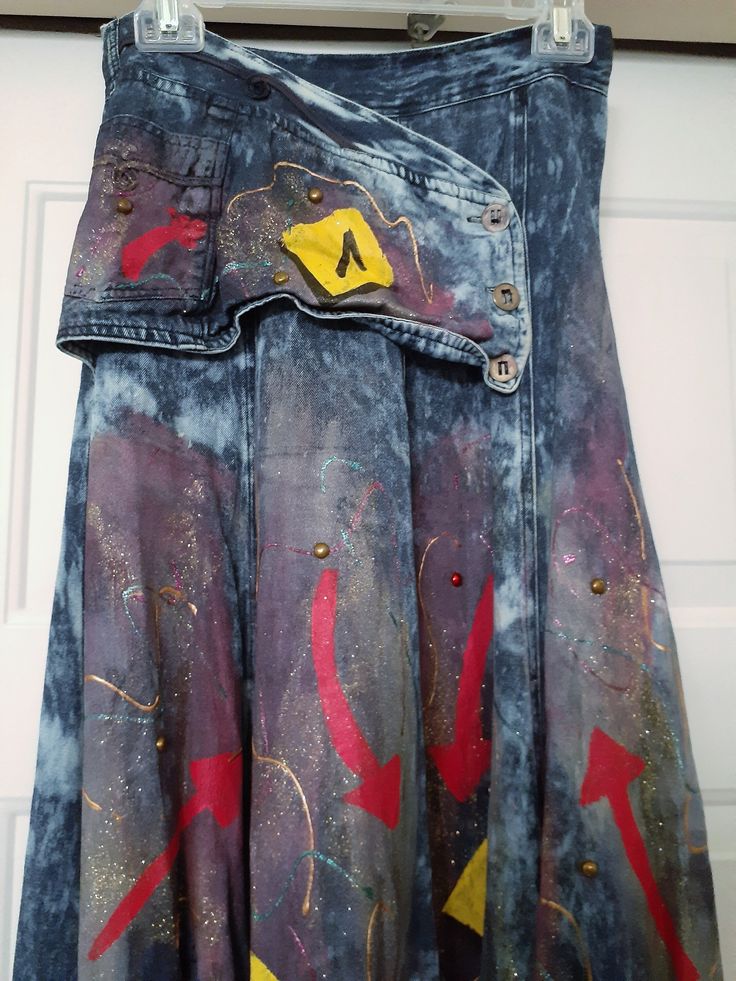 VTG ATTENTE Hand Painted Denim Rayon Blend Maxi Skirt Long with Button Panel at the front Blue. Size 8.  Stunning Boutique design. Hand Painted Embellished Abstract Retro Designer Look skirt with flared bottom.  Rayon cotton blend.  Matching jacket is available listed separately.  Hand Painted Embellished 65% Rayon / 35% Cotton Panel at the front Zipper at the back. flared look skirt (please see photos) Measurements: Length - Approximately 35" measured from the lower seam of the 2" waistband to the hem edge Waist - Approximately 13" seam to opposite side seam Hip area - Approximately 17" side to opposite side measured laying flat Widens to skirt bottom All measurements and colors are approximate and as close as possible.  Please examine the photos for additional details and conditions whic Blue Denim Skirt With Button Zip Fly, Fitted Blue Skirt With Button Zip Fly, Fitted Blue Skirt, Fitted Denim Blue Denim Skirt With Buttons, Fitted Denim Blue Skirt With Button Closure, Fitted Dark Wash Skirt With Snap Buttons, Blue Skirt With Snap Buttons For Summer, Fitted Cotton Denim Skirt With Snap Buttons, Fitted Medium Wash Skirt With Buttons